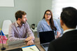 © AntonioDiaz - Serious couple receiving immigration legal advice from attorney