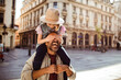 © Davor - Young girl playing with father in city