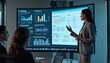 © miss irine - Business meeting. Woman presents data analytics to colleagues on big screen in office. Multiethnic team works at company strategy with graphs. Analytics informaton shown on display. Presentation of