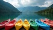 © miss irine - Colorful kayaks rest on a calm lake shore with tree covered mountains beyond. This scenic water provides great outdoor recreation possibilities. Perfect for adventure travel themes.