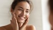 © Tetiana - Refreshing Skin Care Routine: Teenage Girl Embracing Clean Skin In Front Of Mirror. Radiant Woman Smiling, Touching Cheek. Achieving Perfect, Pure, Fresh Skin With Skincare.