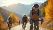 © miss irine - Smiling aged couple cycles on mountain road with autumn trees. Elderly man leads, woman follows, enjoying healthy active retirement trip. Friends bike together.