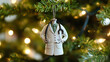 © Sami - Doctor's white coat Christmas ornament with a stethoscope hanging from a tree.