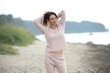 © zhagunov_a - Smiling woman in pink sweater on beach