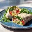 © decorator - Mediterranean Tuna Avocado Wrap A Healthy Lunch on Blue Ceramic Plate Fresh Ingredients