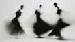 © Belvedere studio - Dancers moving gracefully in flowing black dresses with blurred motion effect in a minimalist setting