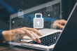 © saranyoo - A businessman typing on a laptop with virtual padlock icons and binary code, symbolizing data protection, cybersecurity, and secure information technology systems.