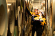 © Montri - two Industrial engineers inspecting large metal rolls in warehouse storage. Wearing safety uniforms and helmets. inventory check, manufacturing logistics, and factory teamwork. engineer, two worker.