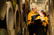 © Montri - two Industrial engineers inspecting large metal rolls in warehouse storage. Wearing safety uniforms and helmets. inventory check, manufacturing logistics, and factory teamwork. engineer, two worker.