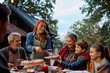 © Drazen - Happy multi-generation family enjoying in Thanksgiving pie on patio.