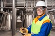 © BillionPhotos.com - Confident engineer with safety helmet in factory