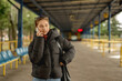 © tan4ikk - Girl Talking On Phone In Spring While Waiting For A Bus At The Bus Station