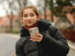 © tan4ikk - Sweet Girl With Smartphone Against A Backdrop Of A Spring City