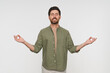 © InsideCreativeHouse - Young tranquil man in casual clothes standing isolated on white background makes mudra gesture meditates feels internal balance having healthy habit, wellbeing harmony no stress concept