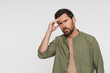 © InsideCreativeHouse - Portrait, man and pain with headache in studio of stress, vertigo and burnout pressure. Mockup space, male person and migraine for fatigue, muscle tension and brain fog of mistake on white background