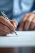 © oksa_studio - Person writing with a pen, signing a contract or official agreement. Focus on legal paperwork and formal procedures