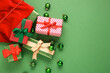 © Pixel-Shot - Beautiful composition with Christmas gifts and balls on green background