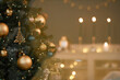 © Seventyfour - Christmas tree decorated with gold and green ornaments standing in foreground, glowing string lights and blurred candles illuminating background, festive holiday setting indoors