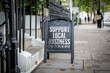 © STOATPHOTO - Support Local Business Sign on City Street. Community engagement and small business awareness in an urban setting