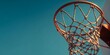 © haidar - Basketball hoop with a clear blue sky background, close-up