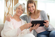 © auremar - cheerful girl with an elderly woman using a digital tablet