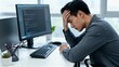 © Bay - Young man experiencing frustration while working at computer desk