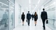 © Strive Studio - People walking in a bright office hallway with glass walls and blurred motion.