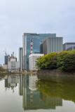 Commerical skycraper offices of Tokio in Japan reflected in water