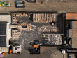 © AmazingAerialAgency - Aerial view of a recycling plant where bales of paper, cardboard, and loose paper create a textured landscape of whites and browns, Berlin, Germany.