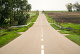 Landscape with long asphalt road, rural Polish region - Podlasie