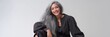 © Andrii Zastrozhnov - Smiling mature asian female with long gray hair and stylish black outfit