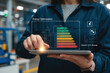 © nattapong - Energy optimization is crucial in modern industries, showcasing female manager using tablet to monitor energy efficiency. digital display highlights energy savings and performance metrics