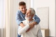 © New Africa - Happy son hugging his father at home