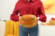 © New Africa - Happy Halloween. Woman with carved Jack-o'-lantern pumpkin at home, closeup