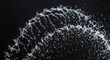 © Ragasa - A dynamic arc of water droplets and spray, captured mid-motion against a stark, black background. It appears fluid and graceful