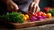 © vasyan_23 - Person chopping fresh vegetables including tomatoes and onions on a wooden cutting board for meal preparation