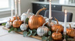 © khozainuzzuhri - Elegant table centerpiece with pumpkins, candles, & eucalyptus sprigs