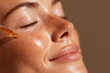 © Denis - Golden skincare cosmetic serum pouring and flowing from pipette on beautiful female woman beauty models face detail. Gentle natural moisturizing hydration and skin care routine.