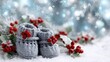 © pvl0707 - Cozy gray baby booties surrounded by winter greenery and red berries on a snowy surface create a festive holiday scene