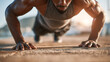 © HISTOCK - Determined man doing push-ups outside, building strength and staying fit