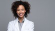© Johannes - medicine profession and healthcare concept  smiling african american female doctor or scientist in white coat over grey background no logos no brands ar 169