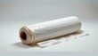 © K-MookPan - Roll of white plastic film on a flat surface, perfect for packaging and preserving various materials and items