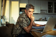 © Marko Geber - Middle-aged man working on laptop at home