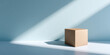 © perfectlab - A brown cardboard box on a white surface with light shining from above it, casting shadows to the right side of the frame