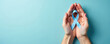 © Vadym - Hands hold light blue ribbon symbol. Awareness campaign for men health issues like prostate cancer. Support and hope for patients fighting illness and disease.