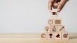 © Ajay - Hand stacking wooden blocks into learning pyramid with education icons, school success strategy concept.
