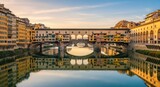 Ponte vecchio in florence during sunset with stunning reflections