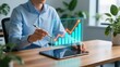 © AbdulMajid - Professional man holding stylus pointing analyzing digital financial charts on tablet, business success, strong leadership
