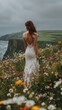 © Usaginikov - Bride in lace dress walking through wildflowers by the sea