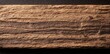 © Julia - In a close-up view, the beautiful texture of a surface is revealed, showcasing alternating dark and light wood grain patterns that display the unique charm of natural materials